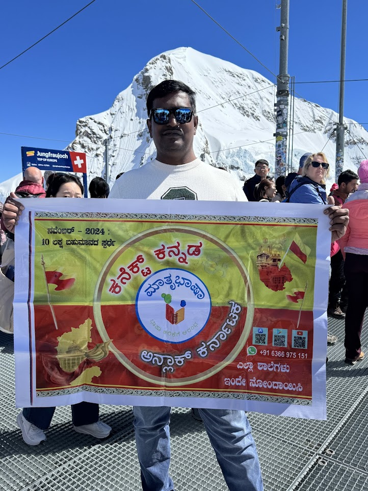 Founder holding a Kannada language banner abroad