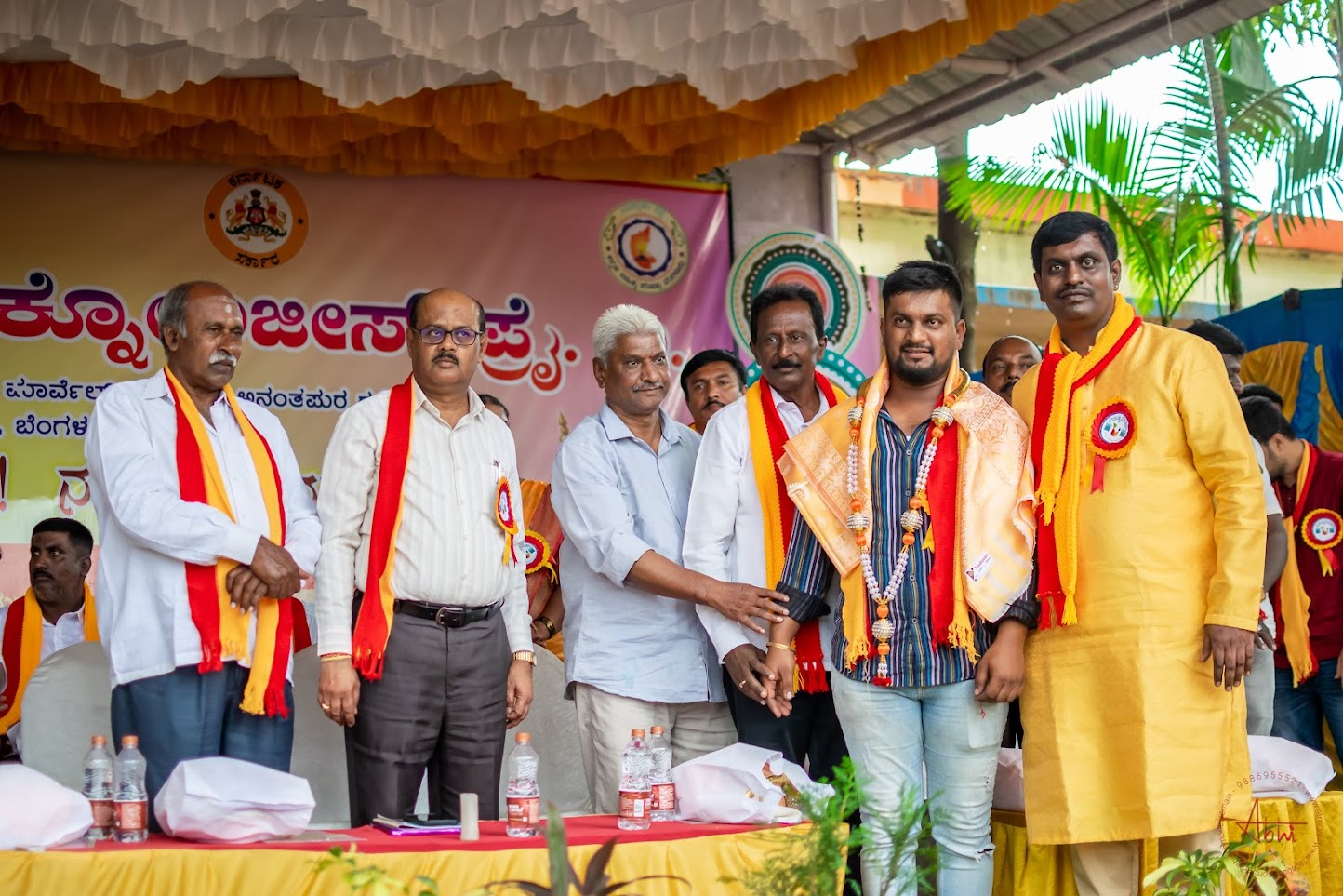 Chandan Ravishankar felicitated on stage at the Rajyotsava program