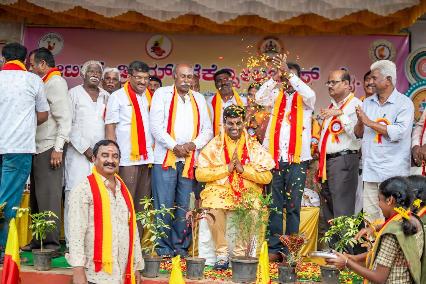 Flower petals showered during a felicitation at the Rajyotsava program