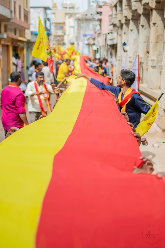 The 1,300-ft Kannada flag carried across a narrow street during the 2023 flag march